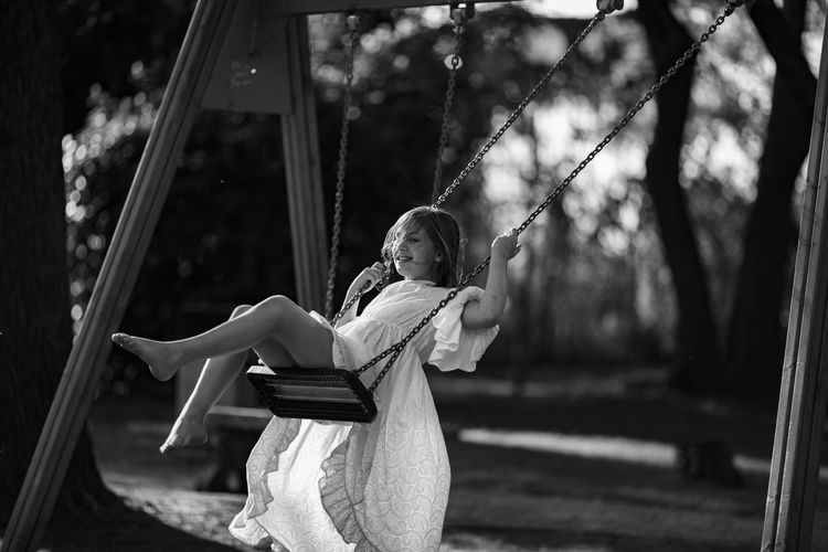 Girl swinging at playground