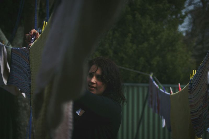 Young woman drying clothes
