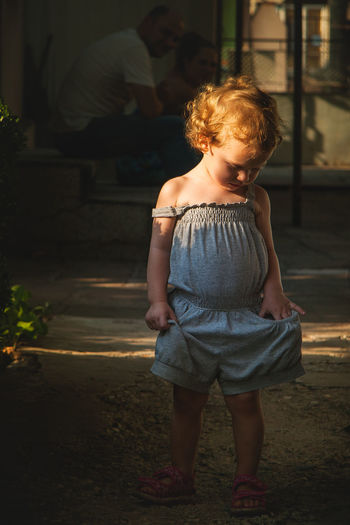 Full length of cute girl standing in yard