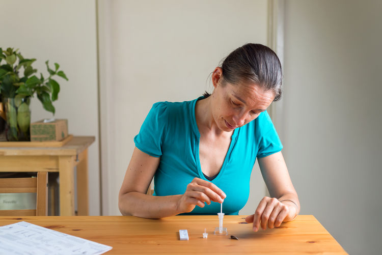 Woman working on antigen at home