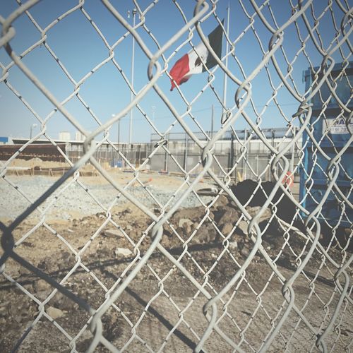 Close-up of chainlink fence against sky