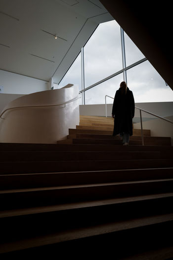 Low angle view of woman walking on steps
