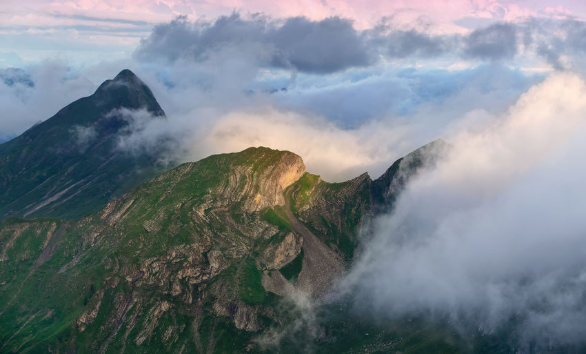 Panoramic view of majestic mountains against sky at sunrise