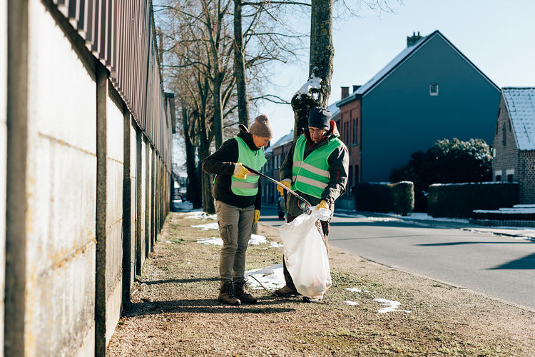 Retired people collecting garbage in the street. volunteer service and sustainability lifestyle