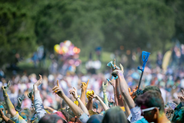 People with arms raised during holi