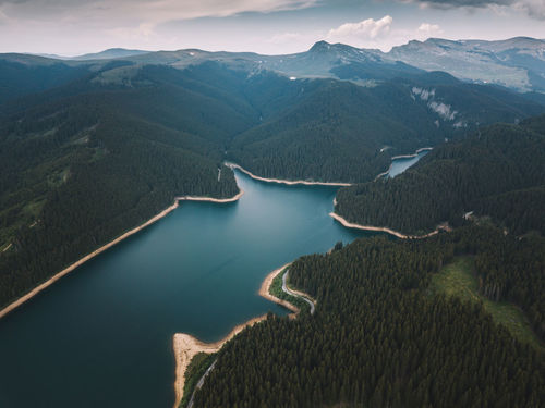 Aerial view of lake and mountains against sky