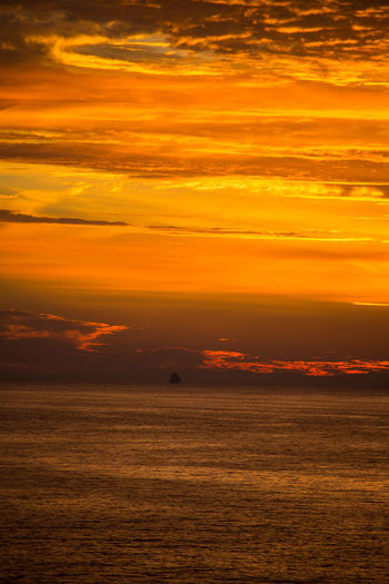 Scenic view of sea against orange sky
