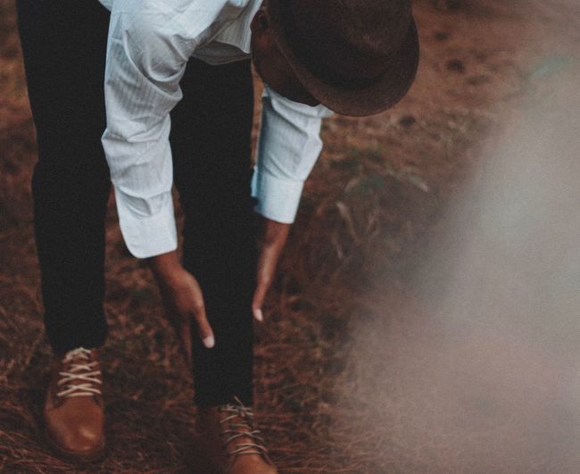 Man bending on field