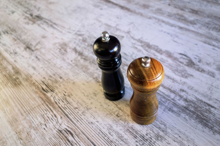 High angle view of salt and pepper shakers on table