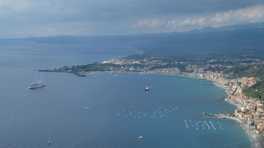 High angle view of sea and bay against sky