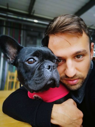 Close-up of portrait of man with dog at home 