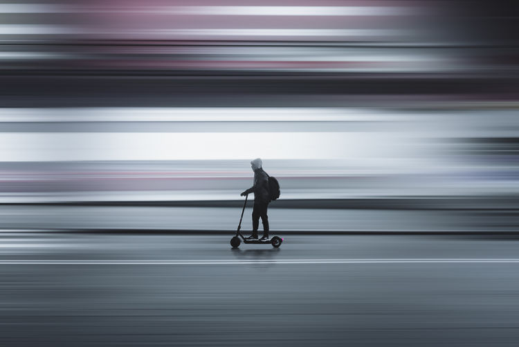 Rear view of man running on street