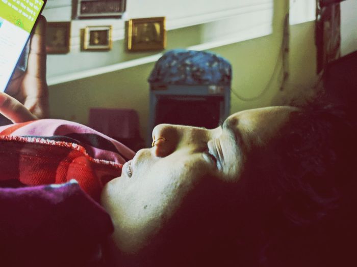 Portrait of man sleeping on bed