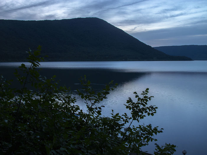 Scenic view of lake and mountains against sky