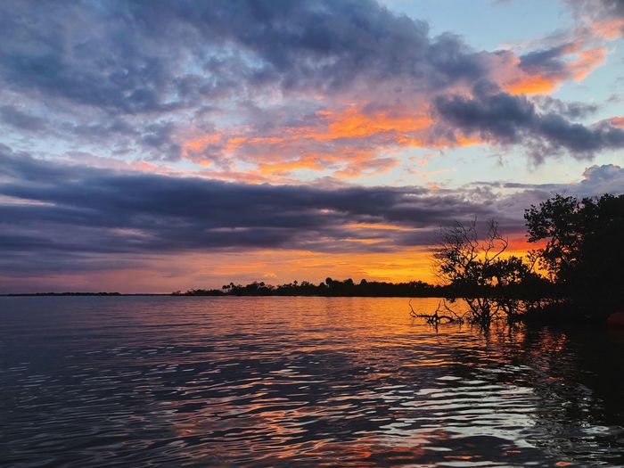 Scenic view of lake against orange sky