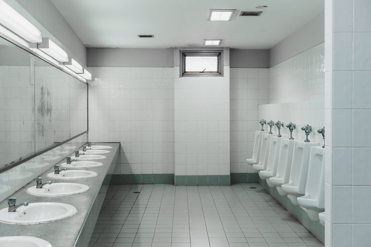 Urinals and sinks in empty public restroom