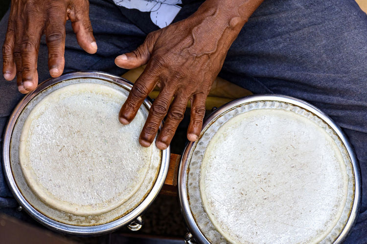 Hands and istrument of musician playing bongo in the streets of pelourinho in salvador in bahia