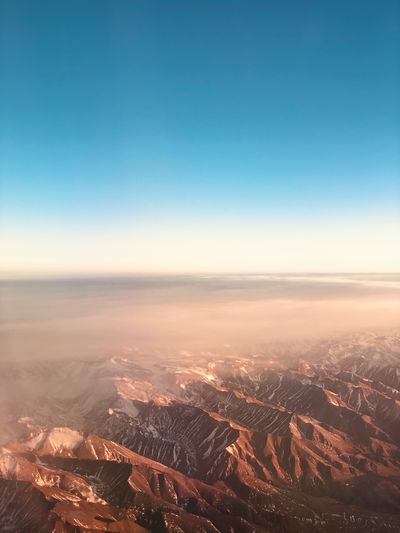Aerial view of landscape against clear sky during sunset