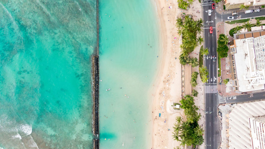 Drone view of kuhio beach, waikiki, honolulu, oahu, hawaii.the beach is protected with concrete wall