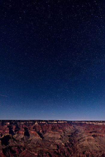 Scenic view of grand canyon against star field at night