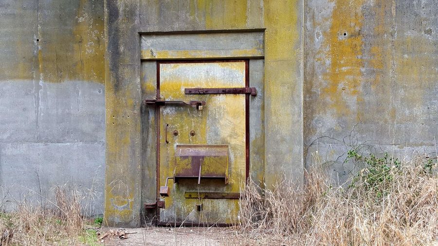 Closed door of abandoned bunker