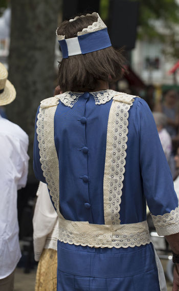 Rear view of man wearing traditional clothing while walking in city