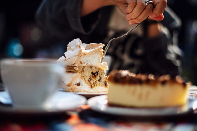 Close-up of hand eating cake