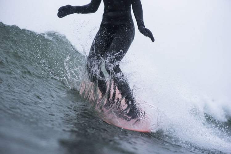 Woman surfing during winter snow