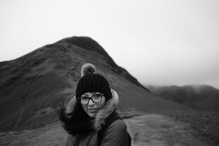Portrait of woman standing against landscape during winter