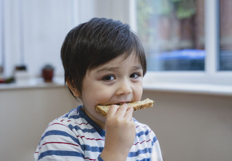 Portrait of cute boy eating food