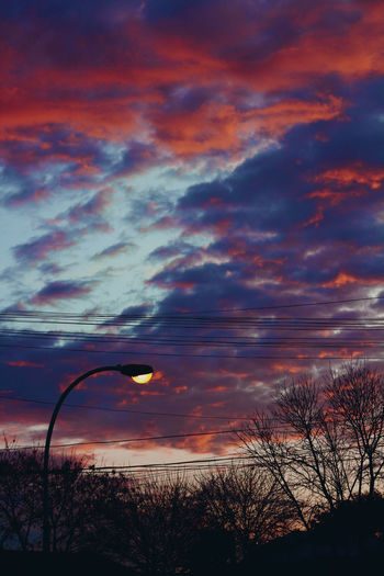 Silhouette trees against sky during sunset