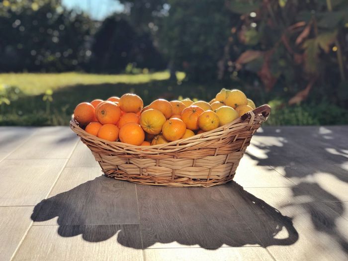 Orange fruits in basket on table