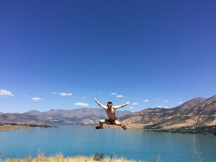 Man surfing in lake against sky