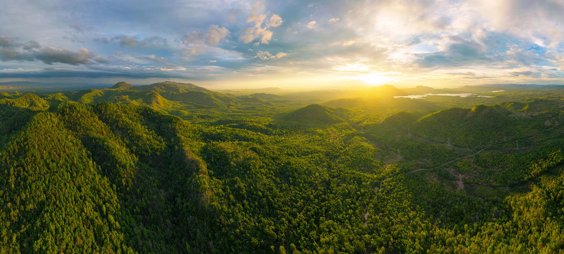Aerial view, panorama landscape sunset over peak mountain with warm light mae moh lampang, thailand.