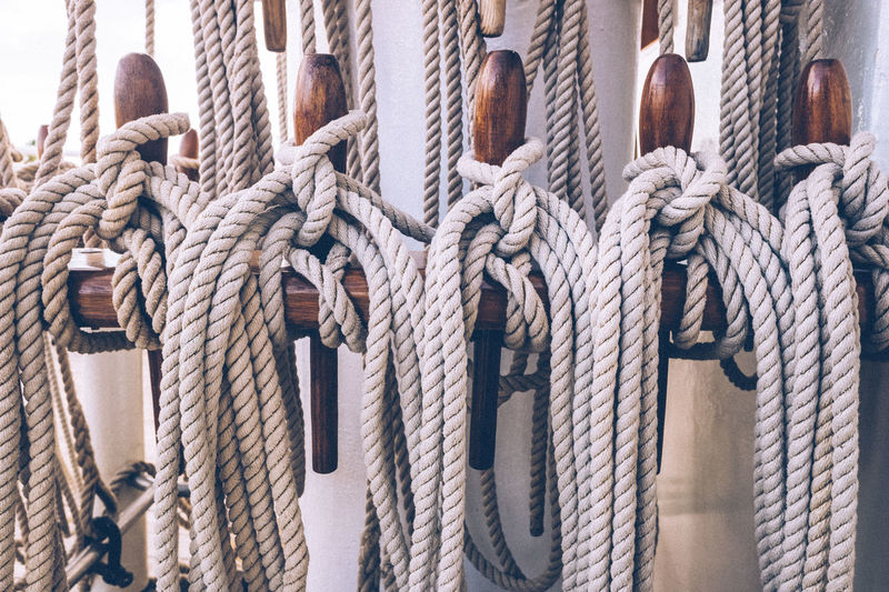 Close-up of rope tied to wood on boat deck