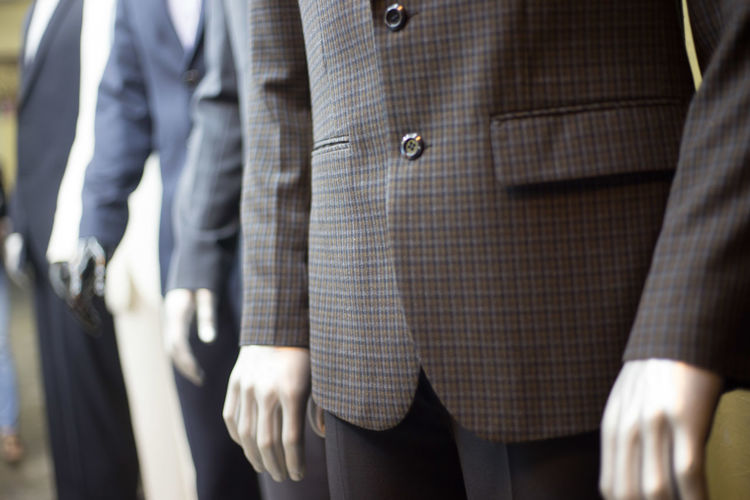 Close-up of suits on mannequins at clothing store