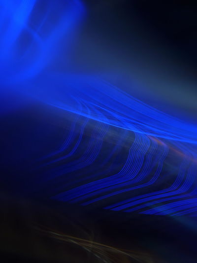 Close-up of light trails against blue background