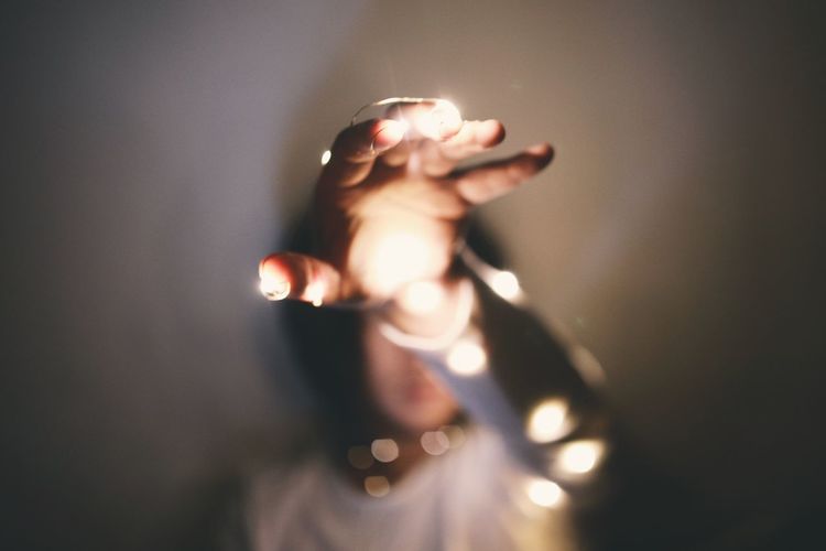 Close-up of sunlight falling on woman hand at home