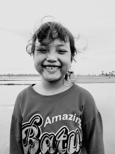 Portrait of smiling girl standing at beach
