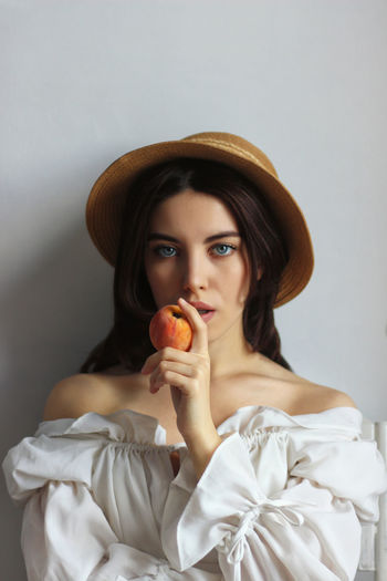 Portrait of young woman holding an apple