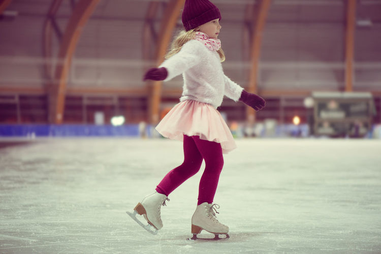 Full length of girl ice-skating
