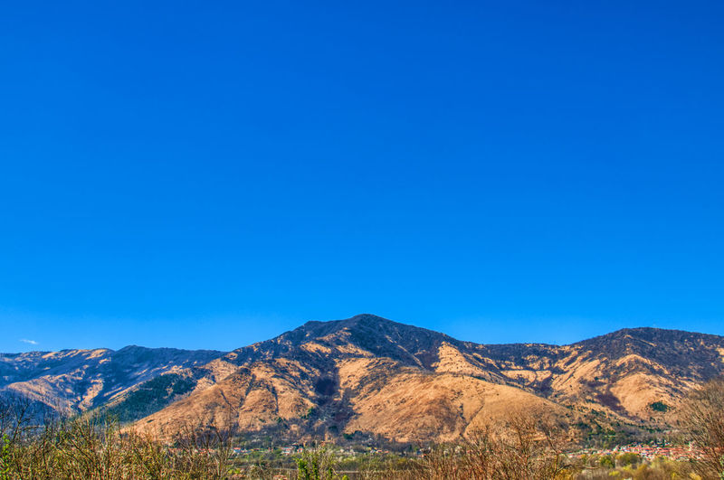 View of mountain range against blue sky