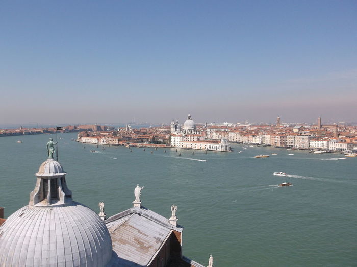 Church of san giorgio maggiore by grand canal and old town against sky