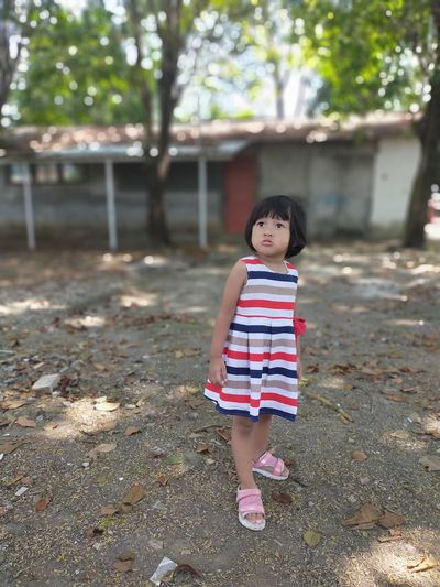 Portrait of cute girl standing on small outdoors