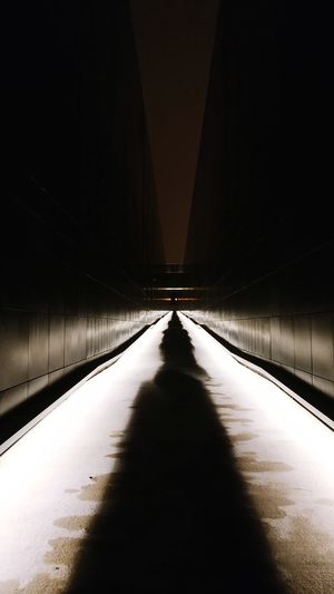 Footpath in illuminated tunnel
