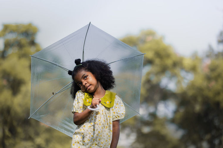 Portrait of young woman holding umbrella