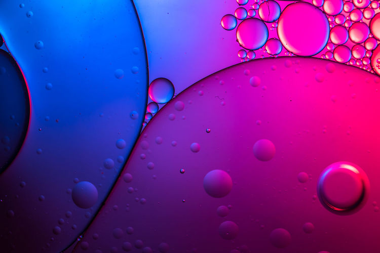 Close-up of water drops on pink glass
