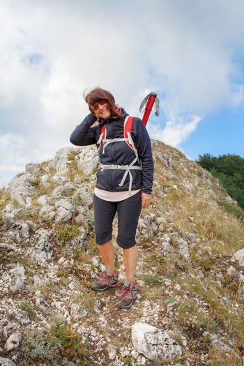 Middle age woman hiking in mountains in a sunny day