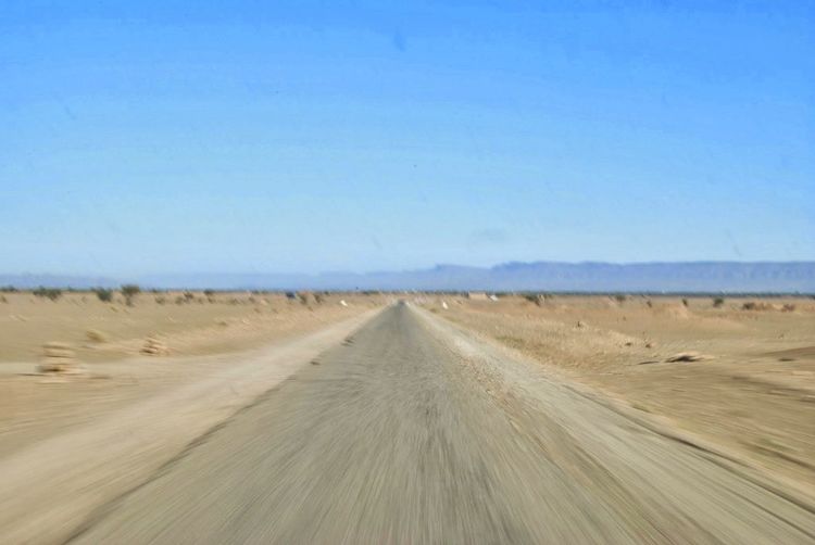 Dirt road passing through a desert