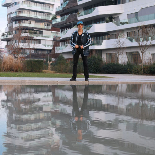 Full length man with reflection on the water